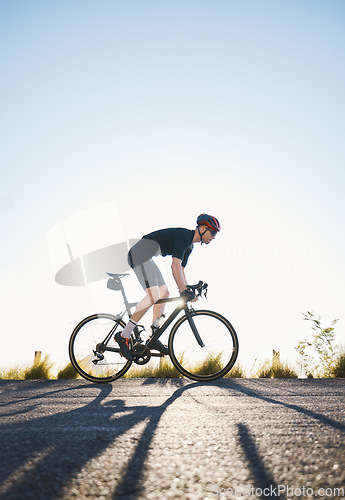 Image of Mountain, fitness and man athlete on bicycle cycling training for a race or marathon in nature. Sports, workout and male cyclist riding a bike for cardio exercise on an outdoor off road trail.