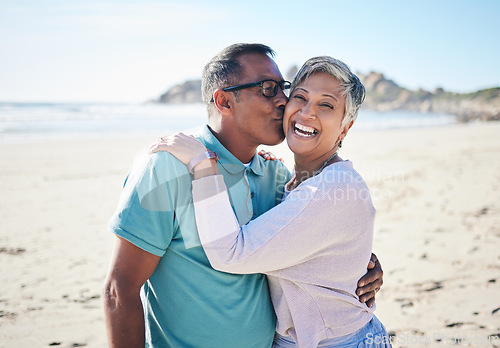 Image of Beach, kiss and portrait of senior couple for bonding, quality time and relax in nature. Love, retirement and happy elderly man and woman embrace by ocean on holiday, vacation and travel in morning