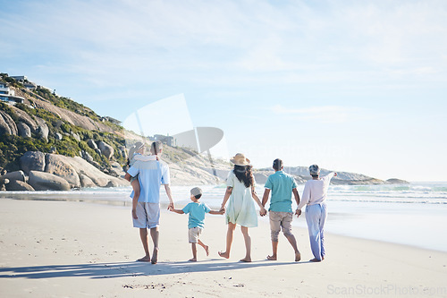 Image of Beach, holding hands and grandparents, parents and kids for bonding, quality time and relax in nature. Family, travel and mom, dad and children walking by ocean on holiday, vacation and adventure