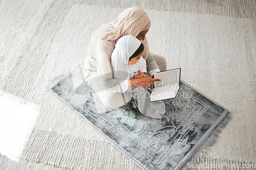 Image of Quran, Muslim kid and parent on floor reading, learning and help girl with religion prayer, study and faith in Allah. Knowledge books, home top view or person teach child worship, praying and respect