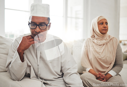 Image of Muslim couple, fight or mature man with depression, problem or divorce conflict in home living room. Sad, crisis or marriage fail for thinking Islamic people in house stress, mental health or anxiety