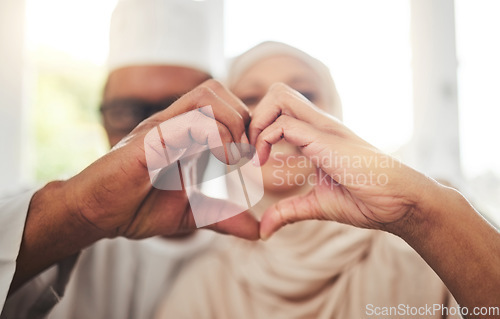 Image of Love, Muslim or senior couple with heart hands for support, trust and care in retirement, bonding or marriage. Emoji icon, Islamic home or Arab man, woman and elderly people together for quality time