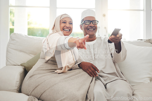 Image of Happy, muslim and watching tv with old couple on sofa for streaming, movie and funny. Television, smile and relax with senior man and woman in living room at home for comedy, retirement and lounge