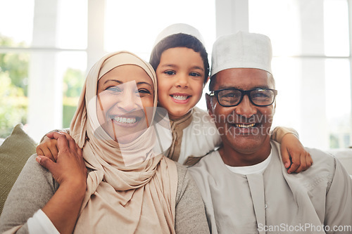 Image of Portrait, Islam and grandparents with child for Eid with happy family in home with culture in Indonesia. Senior Muslim man, old woman in hijab and kid with smile on face on sofa together in lounge.