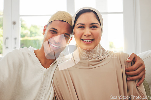 Image of Portrait, Islam and happy couple on couch for Eid with smile, culture and love in home in Dubai. Face of Muslim man, woman in hijab and happiness in marriage on sofa, together in respect and religion