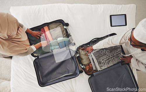 Image of Travel, bedroom and Muslim couple with suitcase packing for holiday, vacation and religious trip. Home, luggage and above of man and woman with clothes in bag for journey, adventure and tourism