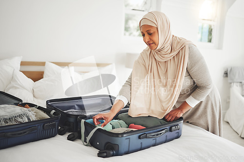 Image of Travel, bedroom and Muslim woman with suitcase packing for holiday, vacation and religious trip. Home, luggage and Islamic female person with clothes in bag prepare for journey, adventure and tourism