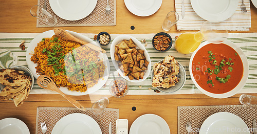 Image of Food, Eid Mubarak and above of lunch for family at table for Islamic celebration, festival and dinner. Ramadan, religion and top view of feast, meal and cuisine for fasting, holiday and culture