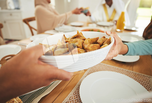 Image of Food, samosa and muslim with hands of family at table for eid mubarak, Islamic celebration and lunch. Ramadan festival, culture and iftar with closuep of people at home for fasting, islam or religion