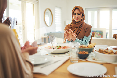 Image of Food, prayer and muslim with family at table for eid mubarak, Islamic celebration and lunch. Ramadan festival, culture and iftar with people praying at home for fasting, islam and religion holiday