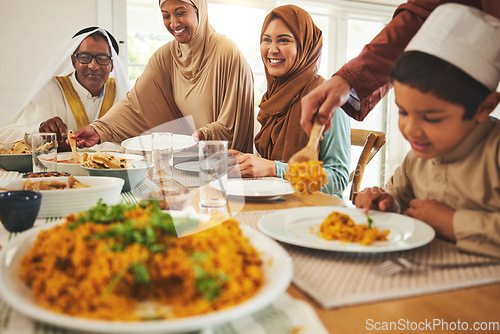 Image of Food, islam and muslim with big family at table for eid mubarak, Islamic celebration and lunch. Ramadan festival, culture and iftar with people eating at home for fasting, happy and religion holiday