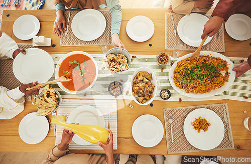 Image of Food, Eid Mubarak and above of family eating at table for Islamic celebration, festival and lunch together. Ramadan, religion and hands with meal, dish and cuisine for fasting, holiday and culture