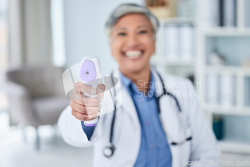 Image of Temperature, happy or doctor with thermometer for healthcare in hospital clinic or medical center. Senior woman blur, infrared laser test or mature nurse screening or checking fever, virus or disease