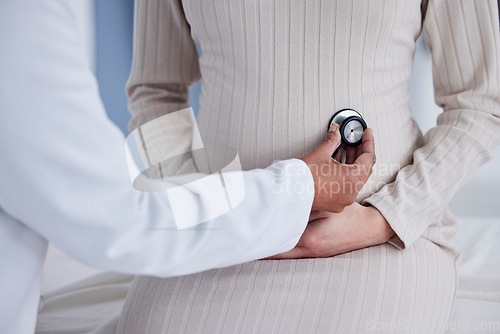 Image of Pregnant, woman and hands of doctor in exam for pregnancy checkup, tummy or patient at the hospital. Female person, medical or healthcare professional checking stomach in maternity at the clinic