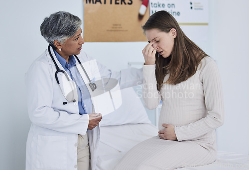 Image of Senior doctor, pregnant woman and headache in consultation, checkup or appointment at hospital. Mature female person, medical or healthcare expert checking patient in maternity or pregnancy at clinic