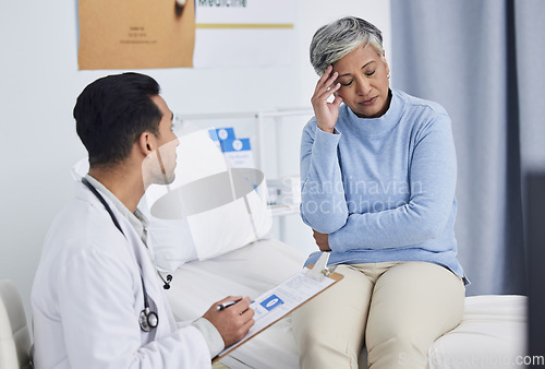 Image of Pain, headache and doctor with patient support, clipboard and healthcare exam or consultation in hospital. Tired, stress and senior woman with medical professional writing notes, helping and advice