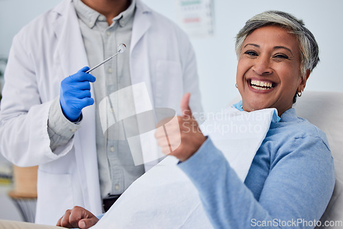 Image of Happy woman, teeth and thumbs up for dentist in dental care, appointment or checkup at clinic. Senior female person smile with like emoji or yes sign in tooth whitening, cleaning mouth or gum care