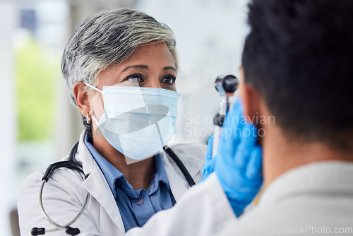 Image of Woman, doctor and face mask with patient for exam, checkup or healthcare appointment at hospital. Female person or medical professional with protection checking ill or sick man with flu at clinic