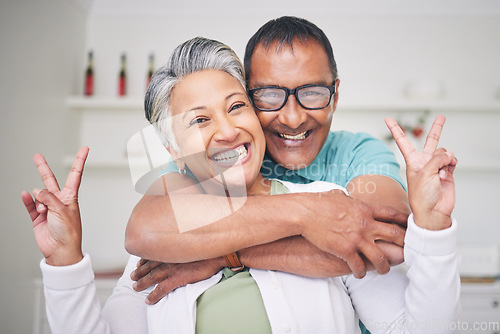 Image of Peace sign, love and smile with portrait of old couple for support, happy and relax. Happiness, kindness and peace with senior man and woman hugging at home for embrace, trust and retirement