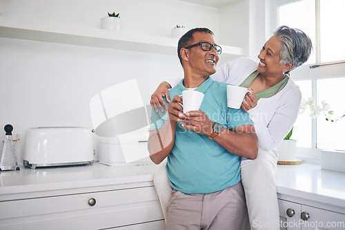 Image of Love, coffee and happy with old couple in kitchen, for morning, relax and hug. Happiness, smile and peace with senior man and woman drinking tea at home for conversation, wake up and embrace