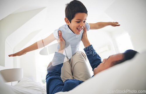 Image of Airplane, game and happy boy child with father on a bed with love, bonding and having fun in their home. Flying, playing and face of kid smile with parent in a bedroom with fantasy, plane or lift