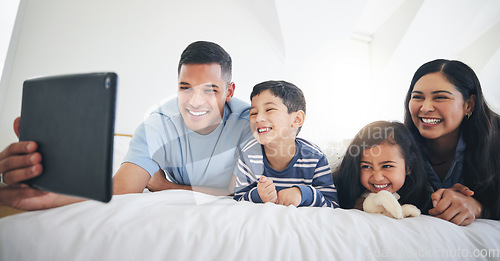 Image of Digital tablet, video call and happy family in bed relax, smile and bond with online communication. Bedroom, selfie and children with parents for profile picture or photo in their home on the weekend