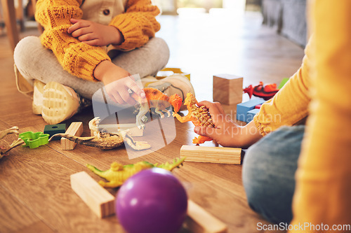 Image of Children are playing with toys, fun and fantasy with friends or siblings at home, bonding and childhood. Relax, playful together and young people on floor with games, adventure and childcare at house