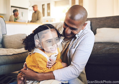 Image of Happy family, smile and father with girl child on living room floor playing, laugh and bond in their home together. Love, hug and kid with parent in a lounge for tickle, fun and games on the weekend