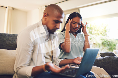 Image of Stress, frustrated and couple on a laptop in the living room of their modern home paying their bills. Upset, technology and young man and woman doing online banking with computer on sofa at a house.