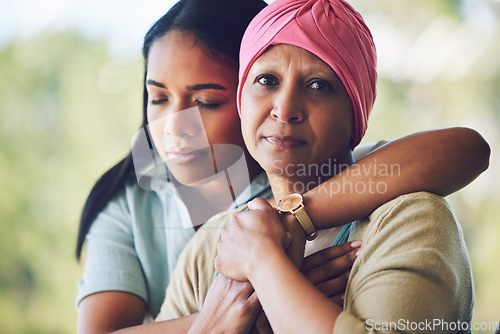 Image of Love, hug and woman with her mother with cancer hugging, bonding and spending time together. Happy, sweet and portrait of a sick mature female person embracing her adult daughter in an outdoor garden