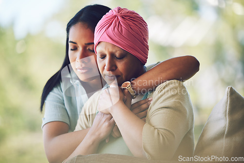 Image of Love, sweet and woman with her mom with cancer hugging, bonding and spending time together. Recovery, chemotherapy and sick mature female person embracing her adult daughter in an outdoor garden.