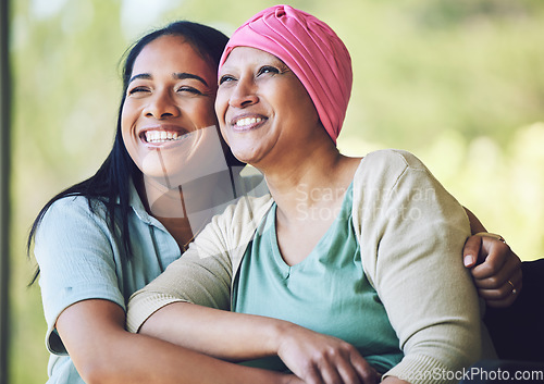 Image of Love, bonding and woman with her mom with cancer hugging, sitting and spending time together. Happy, sweet and sick mature female person embracing her adult daughter with a smile in outdoor garden.