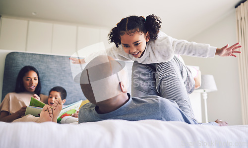 Image of Family home, parents and child playing on a bed together with love, care and security or comfort. Man and girl kid with a happy smile, fun game and quality time in bedroom to fly or relax in morning