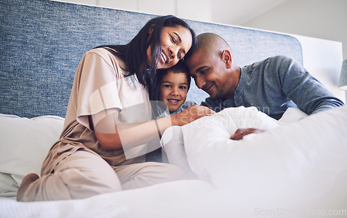 Image of Family home, parents and child in a bed together with love, care and security for comfort. Latino woman, man and kid with a happy smile, commitment and quality time in bedroom in the morning to relax