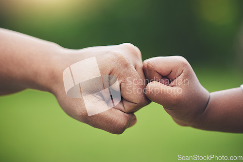 Image of Fist bump, hands of baby and father with support together or gesture of success or trust in family on blurred background. Hand, bumping fists and dad with son or sign of solidarity or celebration