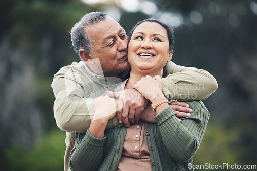 Image of Hug, kiss and senior couple in nature, thinking and love during retirement together. Happy, idea and an elderly man and woman with affection in a garden or park for support or care in marriage