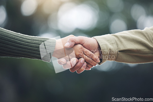 Image of Shaking hands, senior man and people together in partnership, greeting or welcome with trust, bonding or moment in nature on blurred background. Handshake, support and solidarity with a person