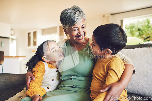 Image of Hug, grandmother or happy kids on a sofa with love enjoying quality bonding time together in family home. Smile, affection or funny senior grandparent with children siblings on house couch laughing