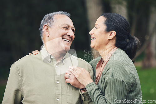 Image of Love, talk and mature couple in nature in an outdoor park with care, happiness and romance. Happy, smile and senior man and woman in retirement embracing and bonding together in a green garden.