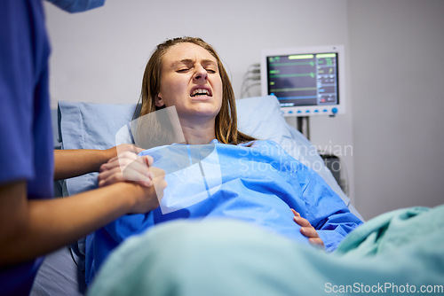 Image of Pregnant woman, clinic and labor with push, holding hands or support in bed, baby and pain. Strong mother, childbirth process and helping hand in hospital bed for infant child, motivation or shouting