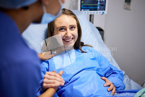 Image of Pregnant woman, labor and hospital with holding hands, bed and support from nurse, excited smile and pain. Strong mother, midwife and helping hand in clinic for infant child, motivation and new life