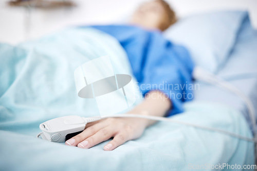 Image of Person, hand or sleeping in hospital bed for medical treatment, surgery and icu operation in clinic. Tired, blur or sick patient lying or resting in emergency room for healthcare or wellness recovery