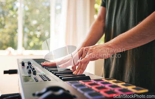 Image of Hands, man and synthesizer piano for music, talent and skills in home studio. Closeup, musician and playing electrical keyboard for audio performance, sound artist and learning notes on instrument