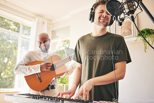 Image of Piano, microphone and friends singing with guitar in home studio together. Electric keyboard, acoustic instrument or recording for collaboration, creative music production and headphones of happy men