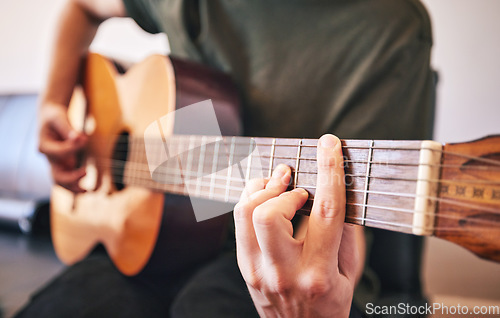 Image of Hands, person and guitar for music, talent and skills in home studio. Closeup, musician and singer playing acoustic instrument for audio performance, artist and learning notes for sound production