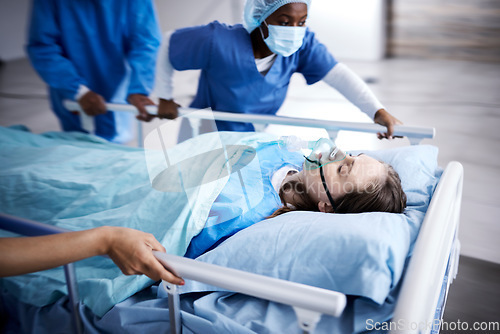 Image of Hospital, bed and patient with doctors running in surgery, emergency and support for healthcare service. Theatre, surgeon and sick child with medical people or nurses in speed for crisis and problem