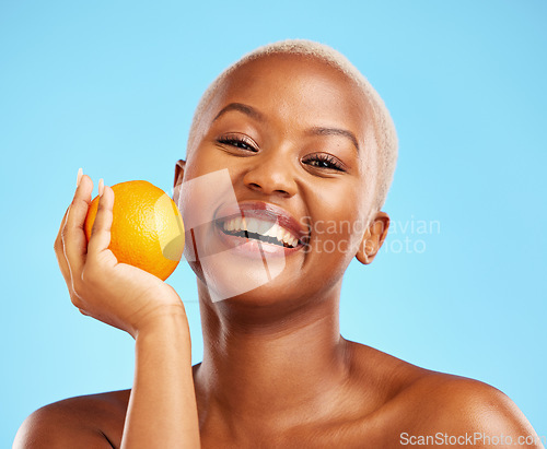 Image of Orange, portrait and black woman with skincare, natural beauty and dermatology on a blue studio background. Female person, face detox or model with citrus fruit, cosmetics and wellness with vitamin c