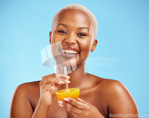 Image of Happy black woman, portrait and orange for vitamin C, diet or natural nutrition against a blue studio background. African female person smile with citrus fruit and straw for healthy wellness or juice