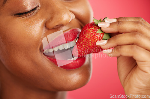 Image of Strawberry, lipstick and woman lips eating, eco friendly product and color choice or dermatology. Happy mouth of african person or model with skincare, fruit and vegan makeup on studio red background