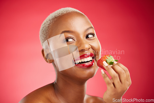 Image of Beauty, thinking face and a woman with a strawberry on a red background for health and wellness. Black female aesthetic model with a smile, makeup and fruit for nutrition and healthy diet in studio